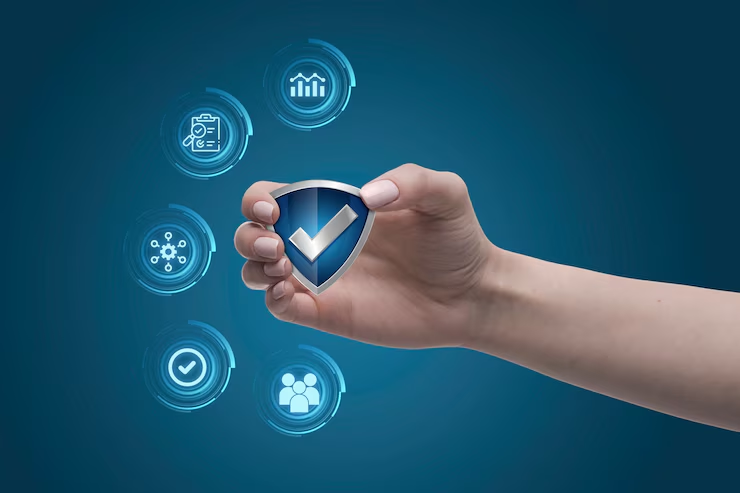 A hand holding a blue shield with a white check mark in the center, symbolizing trust and security. Surrounding the hand are digital icons representing data, analytics, teamwork, verification, connectivity, and tasks, set against a futuristic blue background.